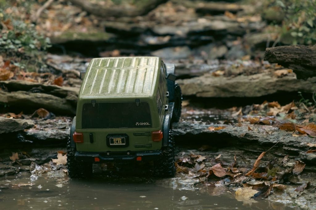 Remote control truck navigating rocky terrain in autumn forest
